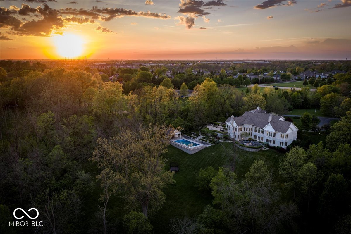 Aerial sunset view of the sold Anchorage lakefront estate in Fishers