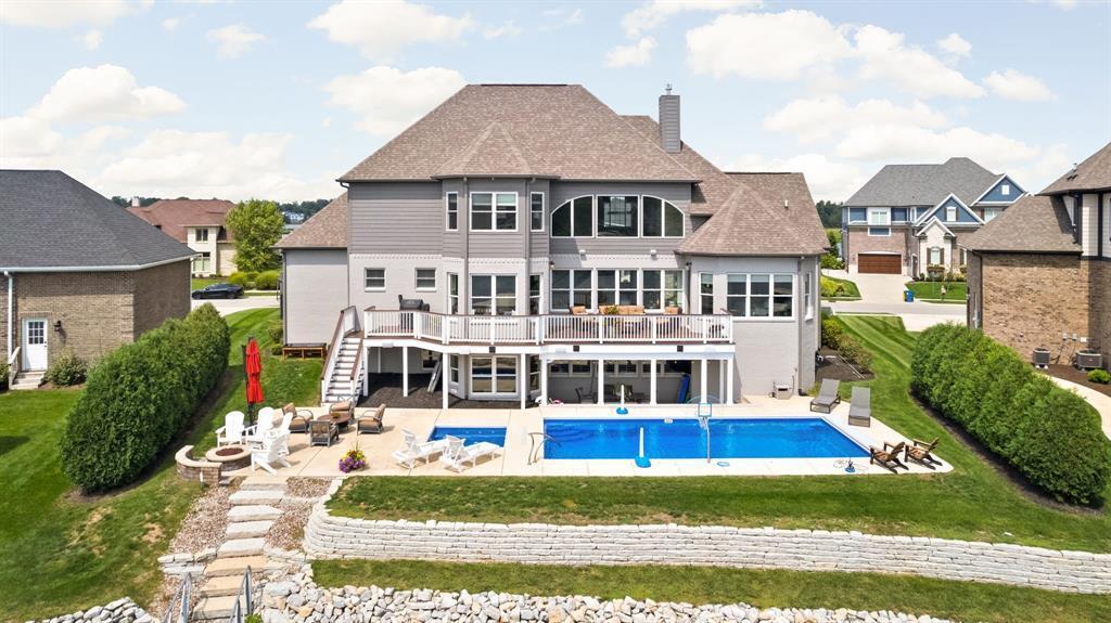 Waterfront view of the sold Lake Ridge Lane home, pool, and dock on Geist Reservoir